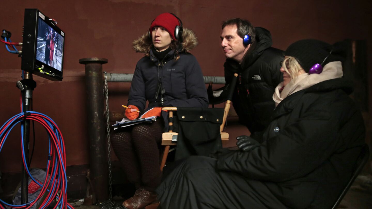 Director Trisha Brock, right, watches as a cold, outdoor scene from the "Hot Mitzvah" episode is filmed along with creator and writer Darren Star, center, and script supervisor Amina El Etreby, left.