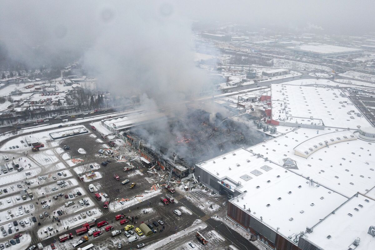 Smoke rises from the OBI mall in Khimki, just outside Moscow, Russia, Friday, Dec. 9, 2022. A massive fire has destroyed a shopping mall on Moscow outskirts, killing one man. The authorities said that Friday's blaze at the OBI mall in Khimki on Moscow northwestern outskirts was caused by violation of safety regulations during welding works. The huge fire erupted early Friday before the mall's opening and raged for hours, engulfing the entire building of 17,000 square meteres. (AP Photo/Kirill Zarubin)