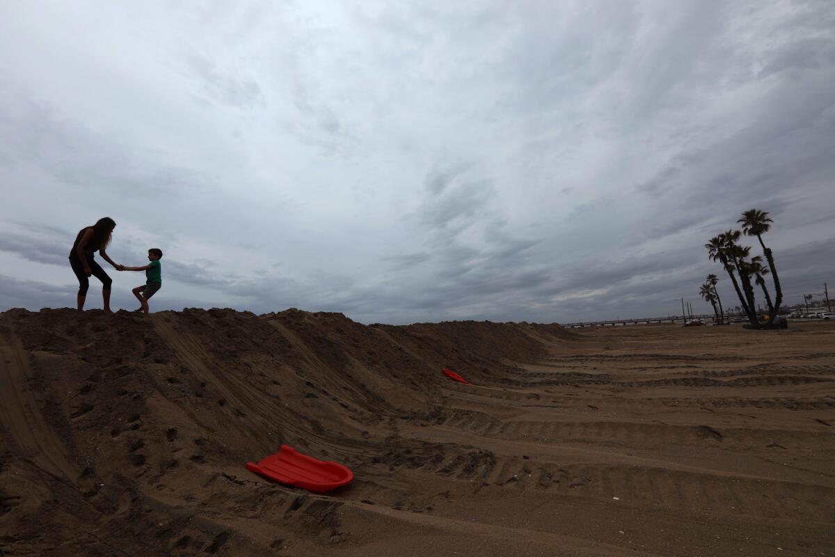 Nadia Davis plays with her  son Elijah on a berm  