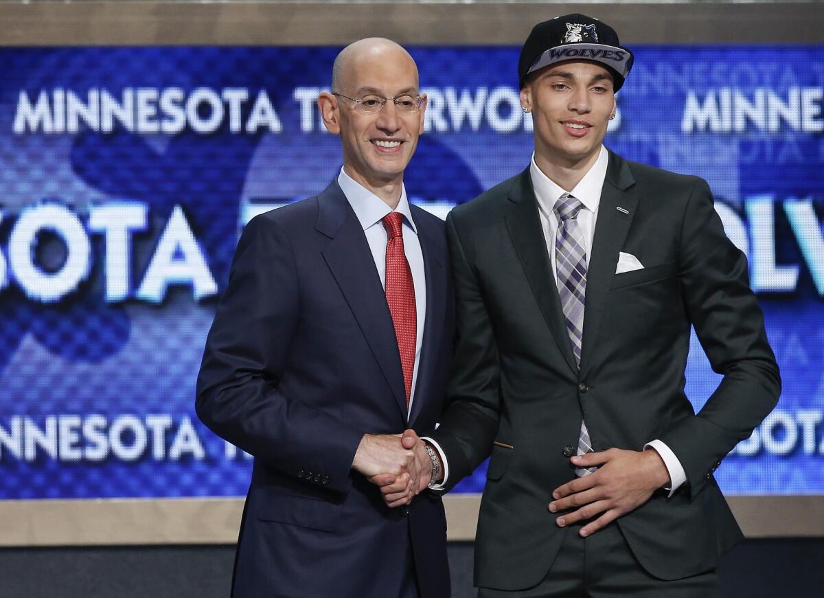 Zach LaVine shakes hands with NBA Commissioner Adam Silver after being selected with the 13th overall pick in the NBA draft by the Minnesota Timberwolves.