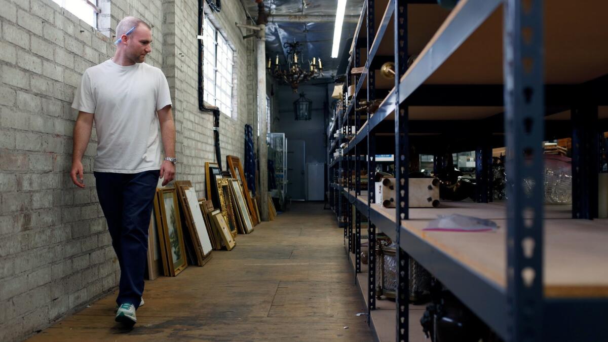Appraiser Ry Fillman looks through inventory in the warehouse at Andrew Jones Auctions in Los Angeles.
