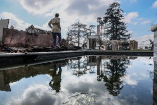 Jana Karibyan walks past the swimming pool in her backyard in Altadena.