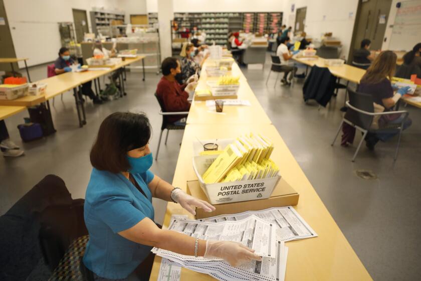 SAN DIEGO, CA - NOVEMBER 04: County workers prepare ballots to be scanned at the Registrar of Voters in San Diego, CA on Wednesday, Nov. 4, 2020. Approximately 370,000 ballots are left to be counted. (K.C. Alfred / The San Diego Union-Tribune)