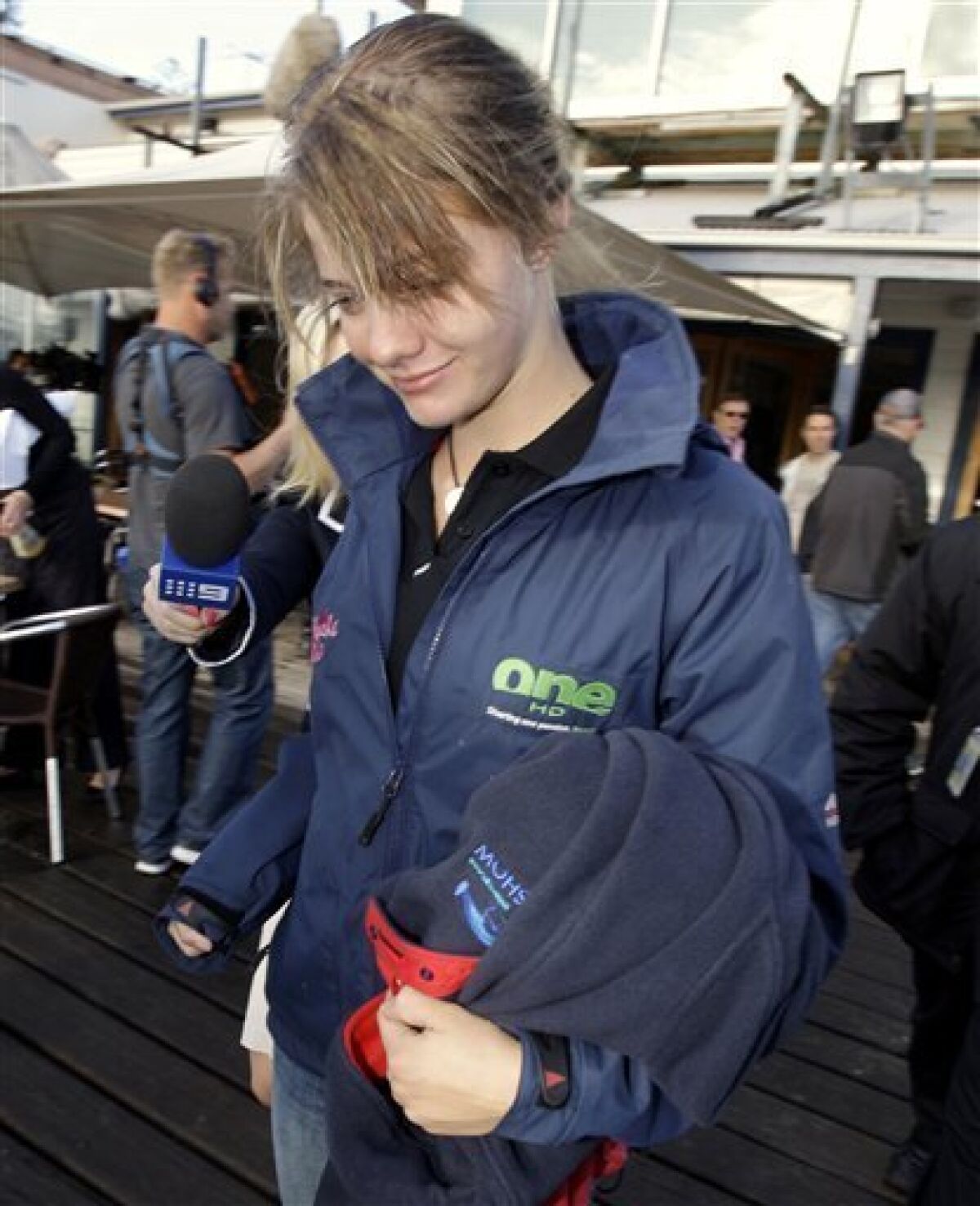 In this file photo from Oct. 18, 2009, teenage sailor Jessica Watson walks to her boat after her final shower on land as she prepares to depart Sydney on her boat Ella's Pink Lady in an attempt to become the youngest person to sail non-stop, solo and unassisted, around the world. Thousands are expected to line Sydney Harbour on Saturday, May 15, 2010, to offer a hero's welcome to 16-year-old Jessica Watson, who has battled 40-foot (12-meter) waves, multiple knockdowns and critics who called her too immature and inexperienced for the treacherous journey. (AP Photo/Rick Rycroft, File)