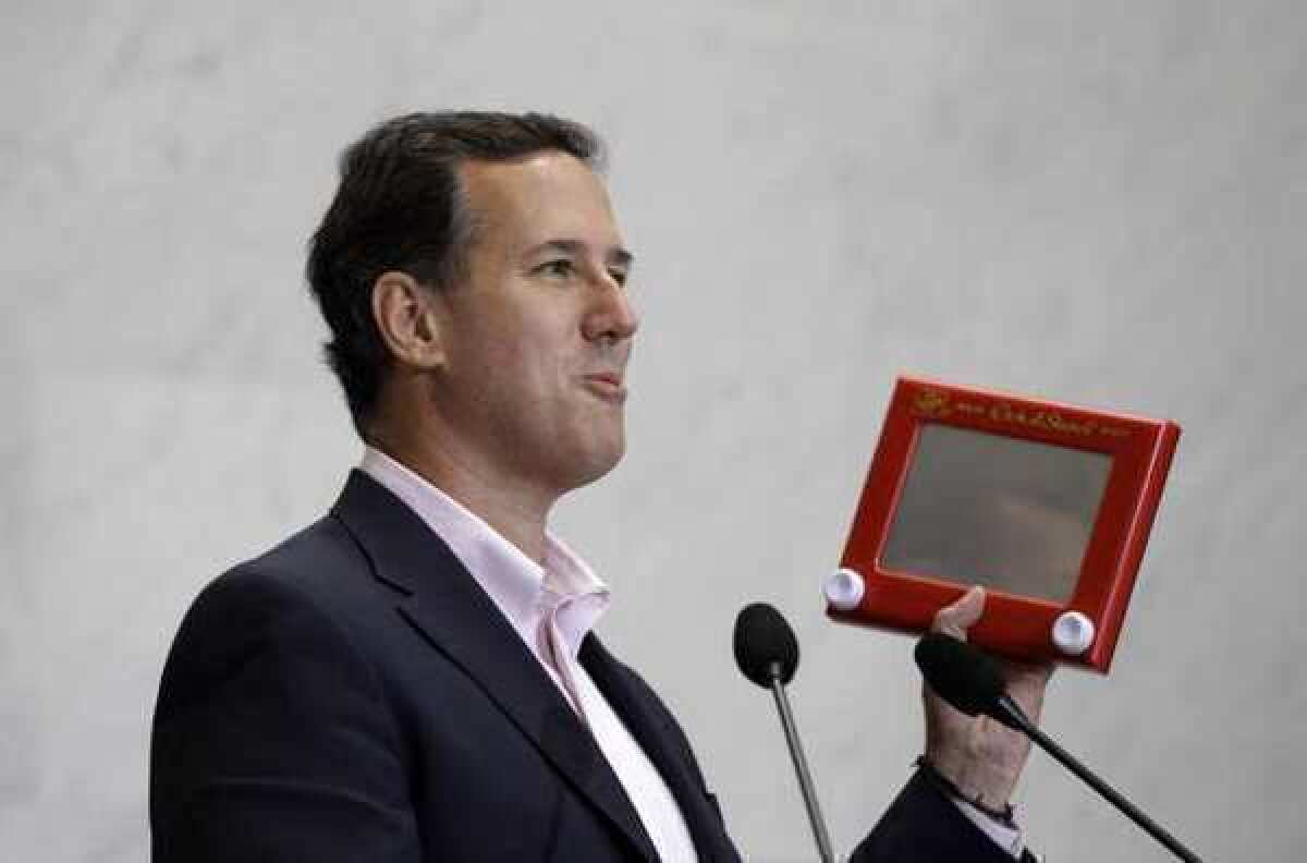 Republican presidential candidate Rick Santorum holds an Etch A Sketch during a campaign stop Thursday.