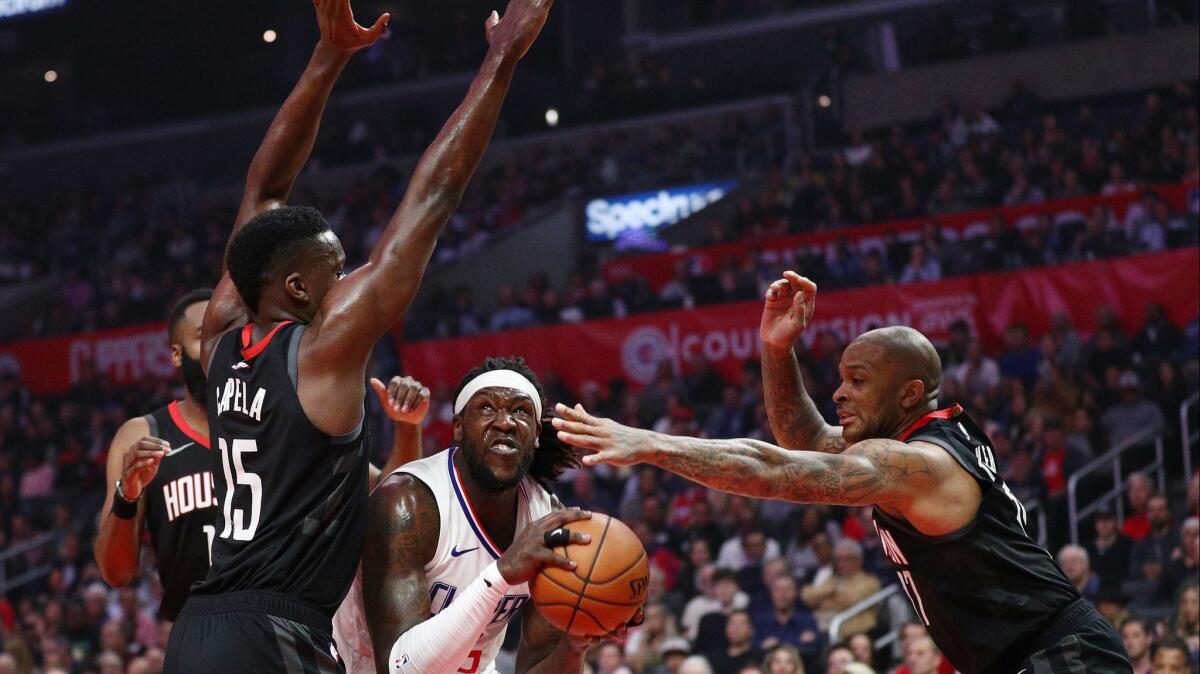 Montrezl Harrell (center) of the Clippers drives to the basket against Clint Capela (15) and P.J. Tucker (right) of the Houston Rockets during the first half at Staples Center on April 03, 2019.