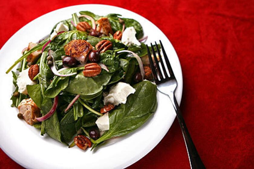 ASSERTIVE: Pecans and goat cheese add texture to chicken, spinach, arugula and dandelion greens.