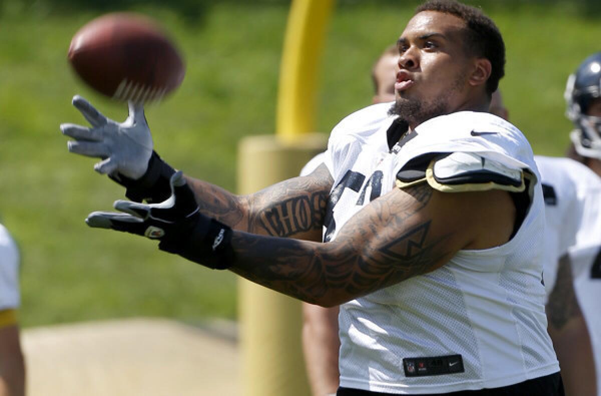 Steelers center Maurkice Pouncey misses the ball as he takes part in a punt-catching drill during training camp this summer.