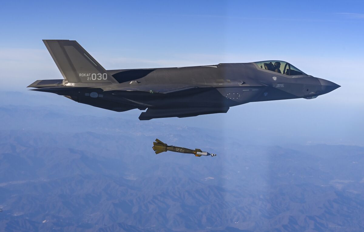 In this photo provided by South Korean Defense Ministry, South Korean Air Force F-35 fighter jet fires a GBU-12 aerial laser-guided bomb at a firing range near its land border with North Korea, South Korea, Friday, Nov. 18, 2022. South Korea's military said Friday its F-35 fighter jets conducted drills simulating aerial strikes on North Korean mobile missile launchers at a firing range near its land border with North Korea. It said a group of eight South Korean and U.S. fighter jets separately performed flight training off the Korean Peninsula's east coast. (South Korean Defense Ministry via AP)