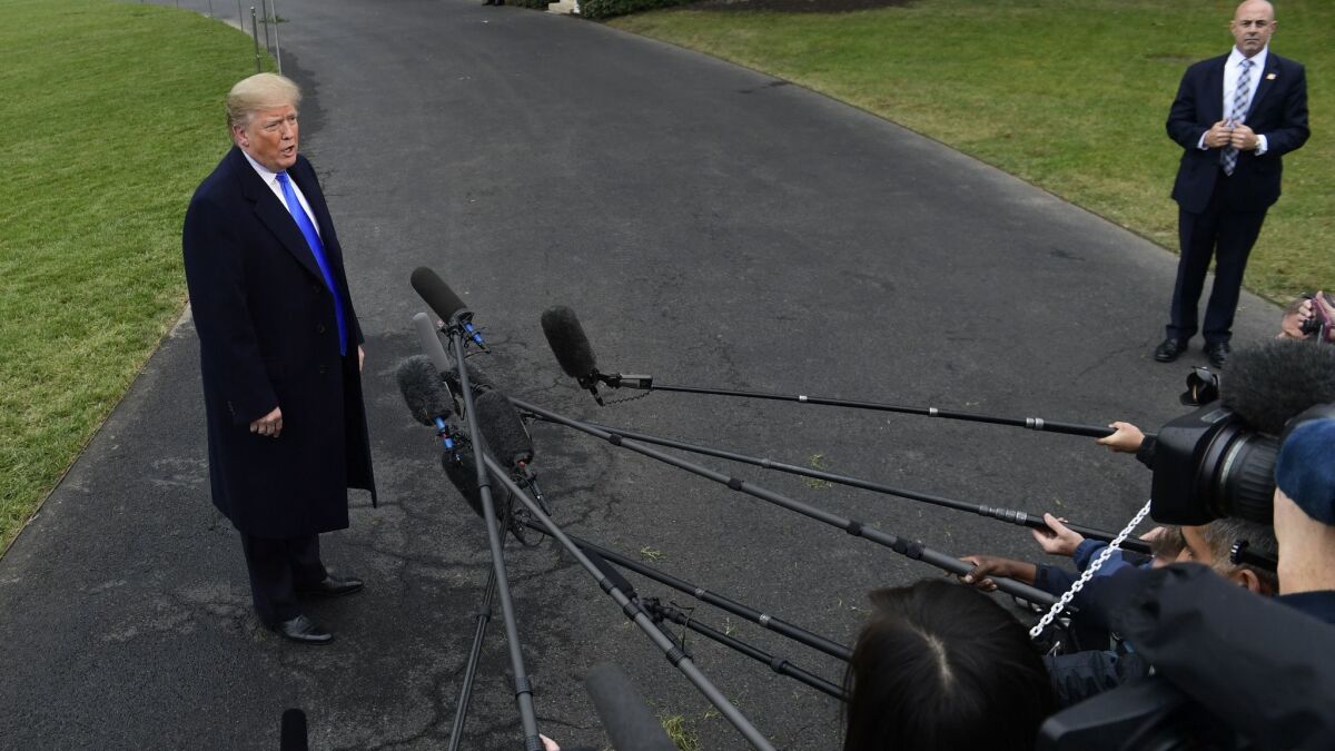 President Trump talks with reporters at the White House on Friday.