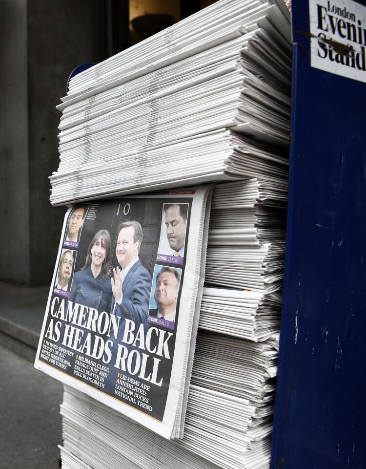A pile of newspapers showing election victory for British Prime Minister David Cameron's Conservative Party are pictured at a news stand in central London on May 8, 2015, a day after the British general election.