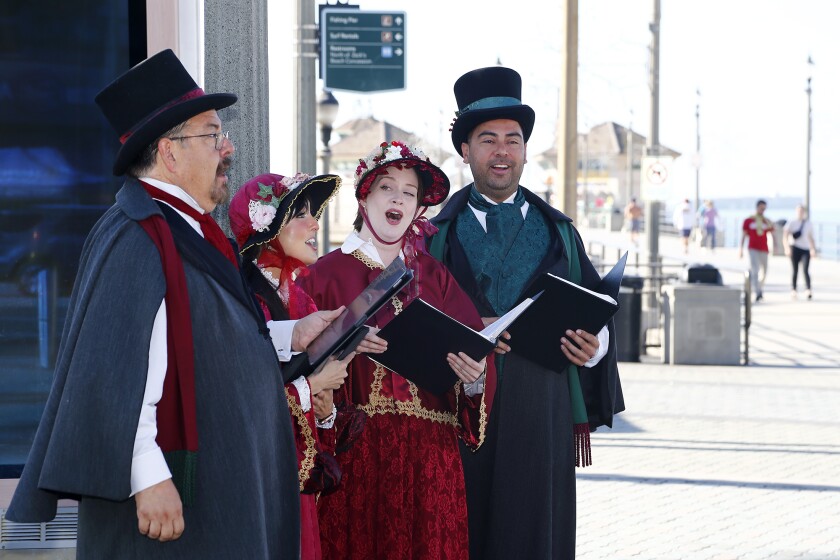 Christmas carolers sing holiday songs during the smooth opening Wednesday of the Surf City Winter Wonderland rink.