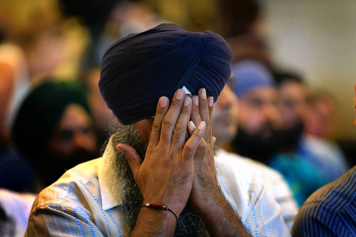 A member of the Milwaukee area Sikh community weeps as he listens to information about the Aug. 6 shooting spree in Oak Creek, Wisc.