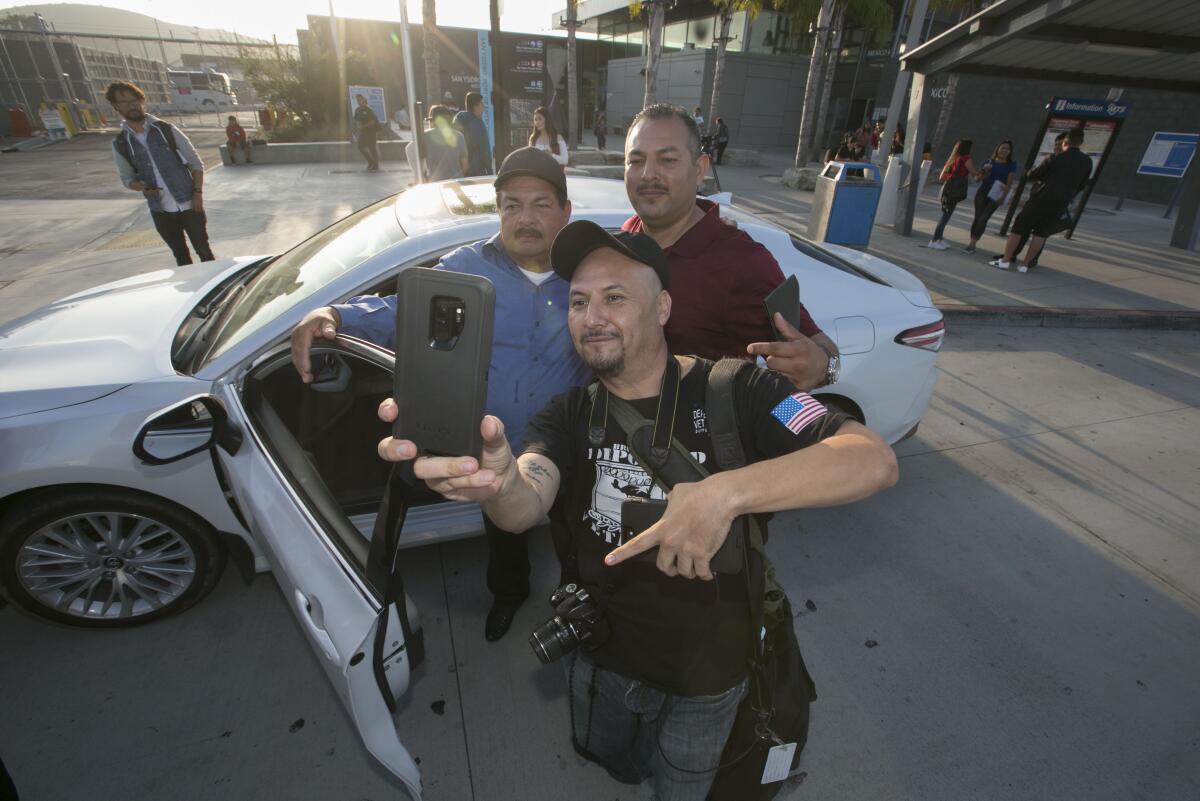 Joaquin Aviles stands with his father and Hector Barajas for a selfie at the San Ysidro Port of Entry PedWest entrance