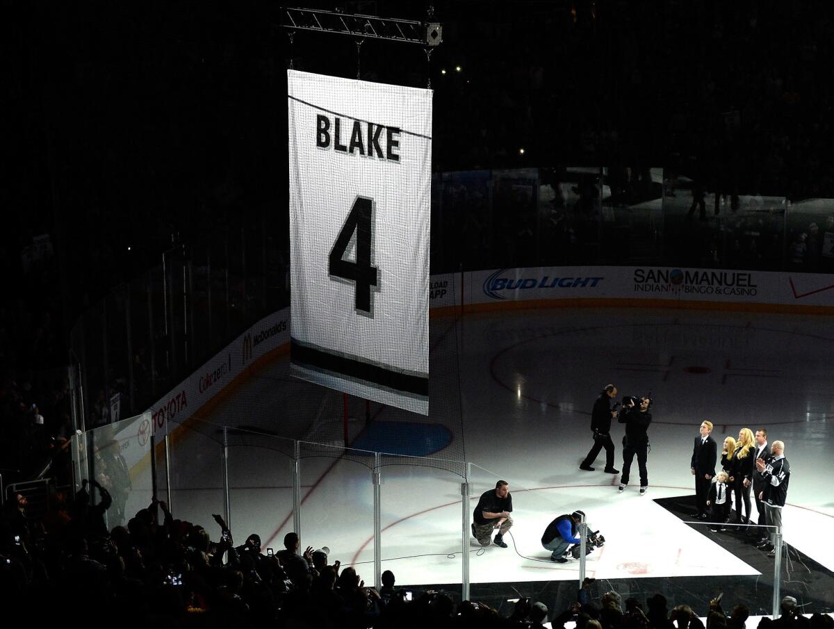 Rob Blake watches along with family members as a banner with his Kings jersey number is raised at Staples Center.