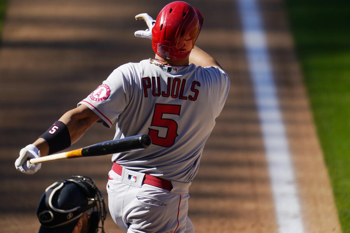 Albert Pujols follows the flight of a two-run home run.