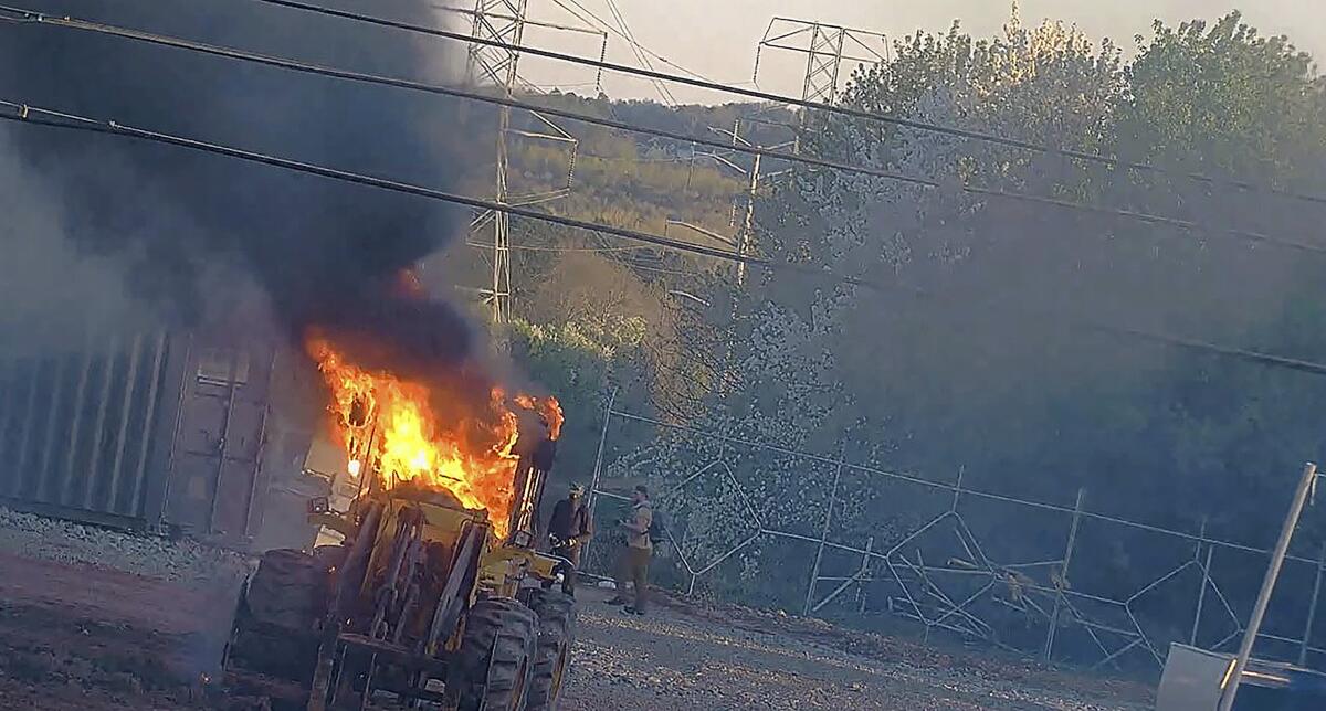 Heavy equipment burns at a construction site.