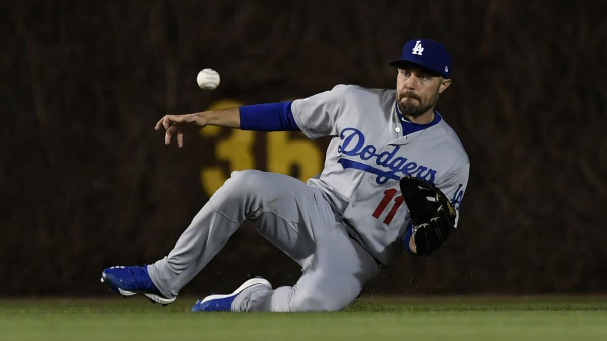 Dodgers center fielder A.J. Pollock catches a fly ball hit by the Chicago Cubs' Cole Hamels on April 24 at Wrigley Field.