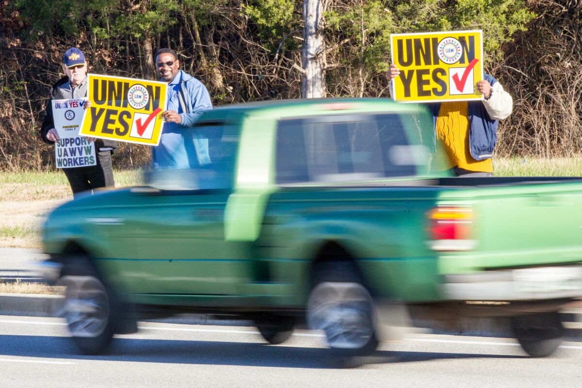 Union supporters hold up signs near the Volkswagen plant in Chattanooga, Tenn., in December.