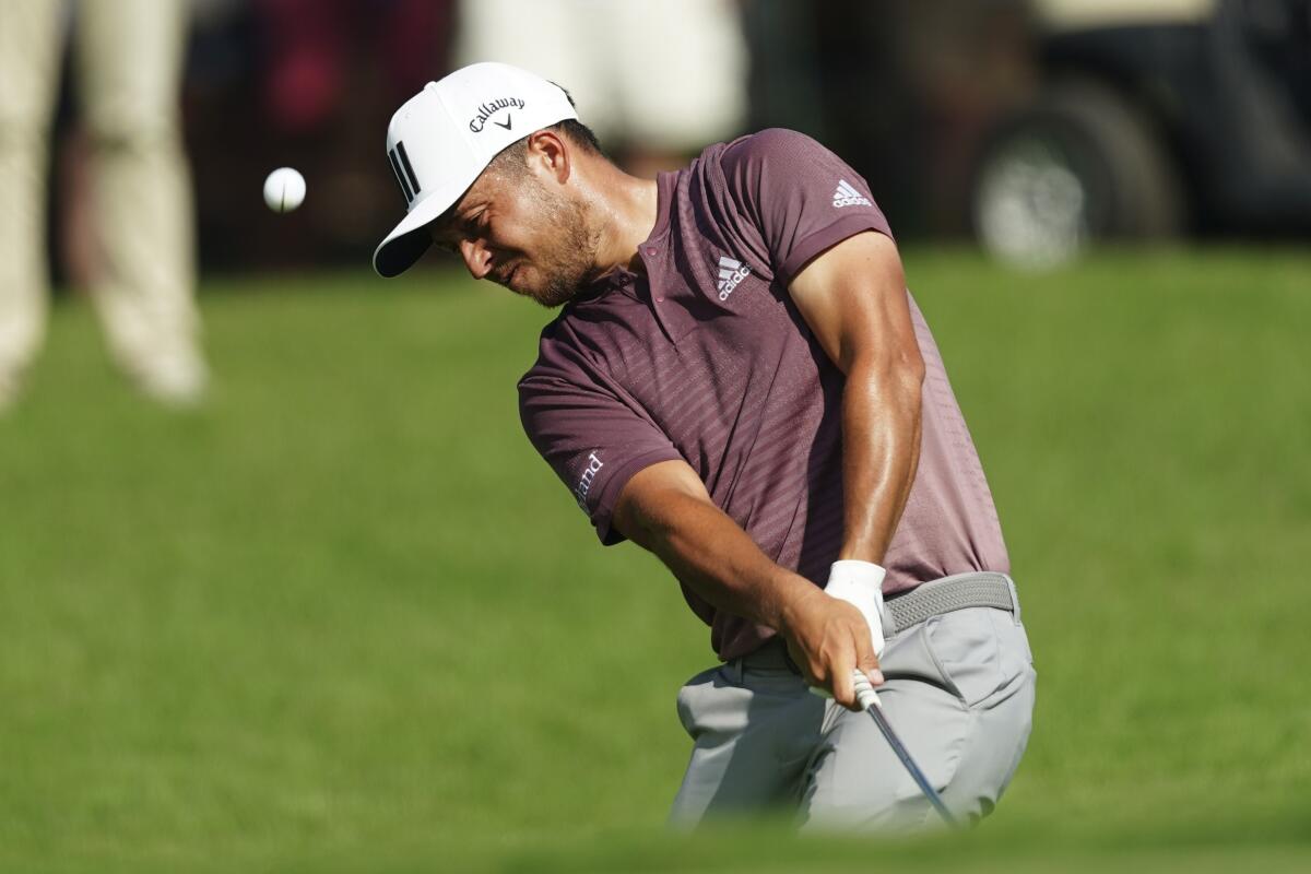 Xander Schauffele chips to the fifth green during the third round of the Tour Championship on Aug. 27, 2022.