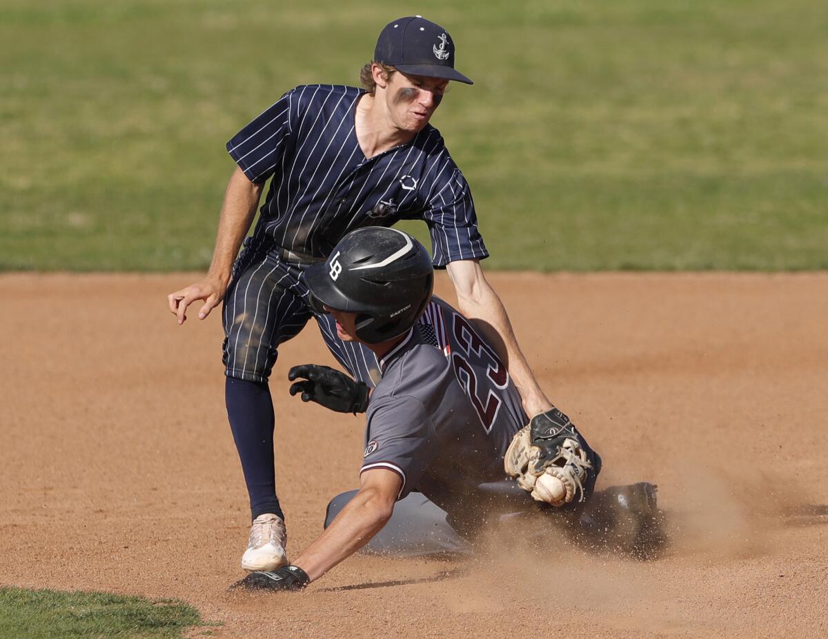 Newport Harbor's Joey Wright, shown applying a tag to Laguna Beach earlier this season, was two for three on Saturday.