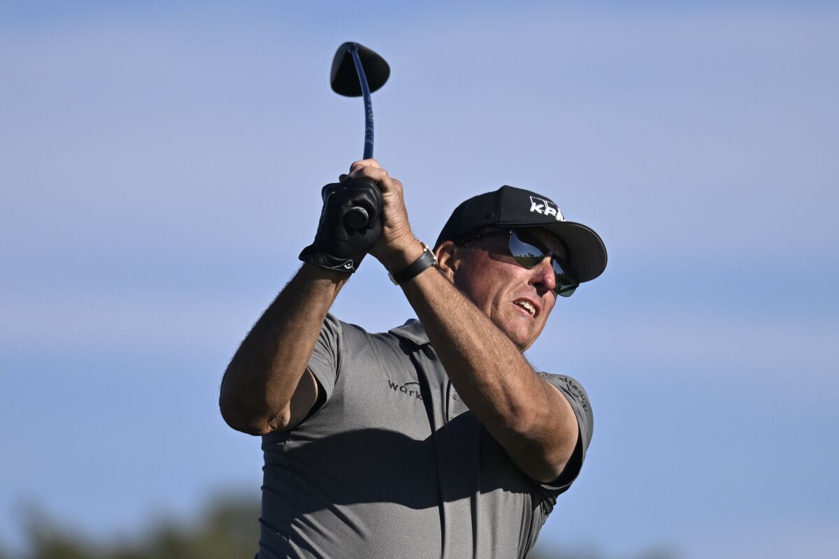 Phil Mickelson hits his tee shot on the fifth hole of the South Course at Torrey Pines during the first round of the Farmers Insurance Open golf tournament, Wednesday Jan. 26, 2022, in San Diego. (AP Photo/Denis Poroy)