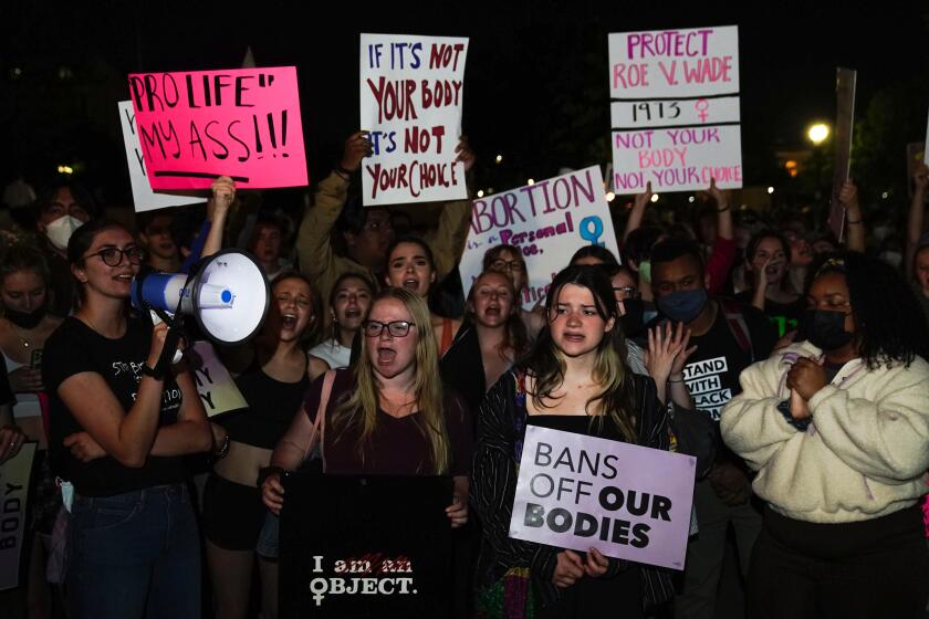 A crowd gathers outside the Supreme Court on Monday night after a purported leak says that Roe vs. Wade will be overturned on May 2, 2022.