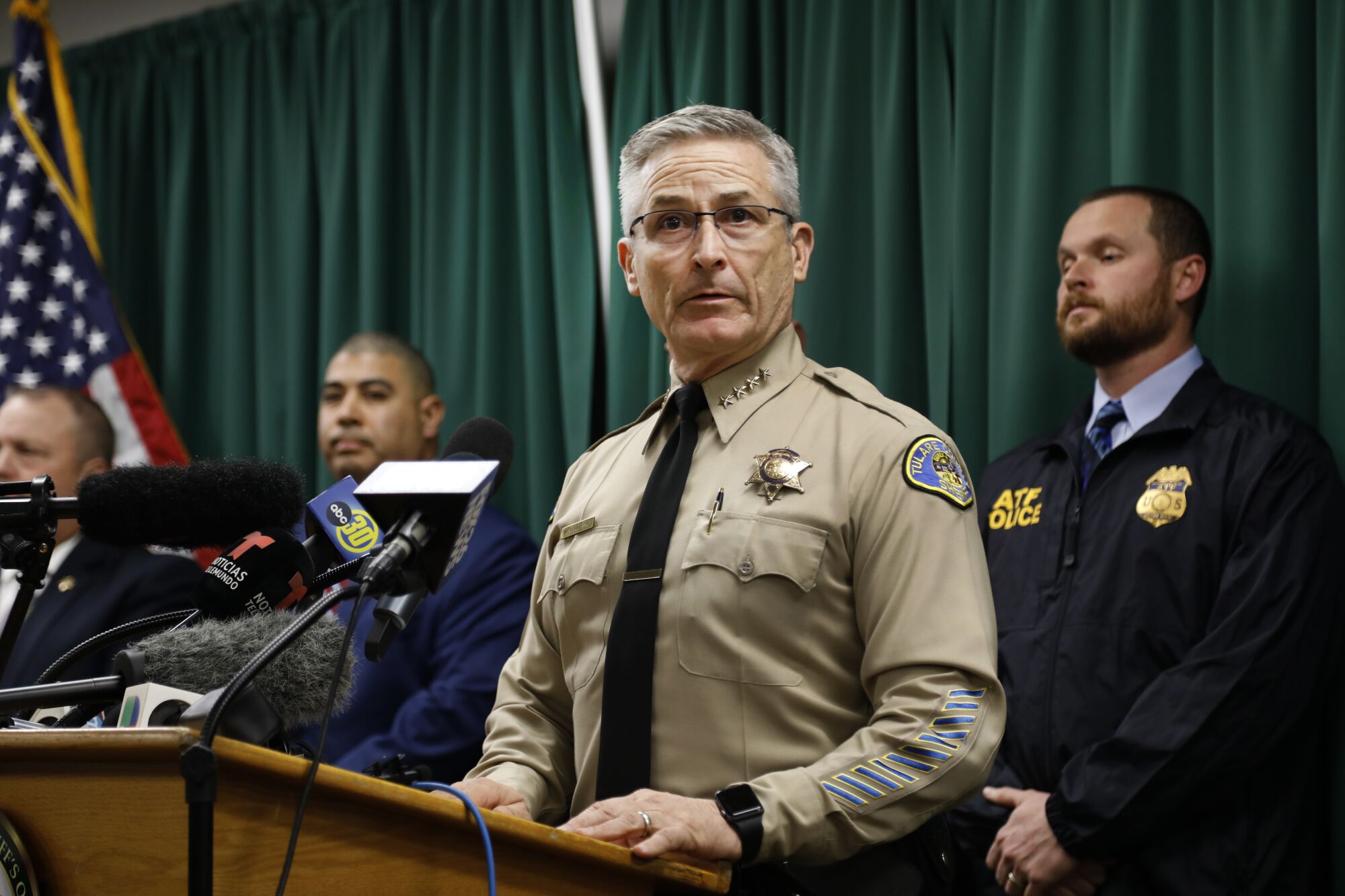 Tulare County Sheriff Mike Boudreaux speaking at a lectern during a news conference