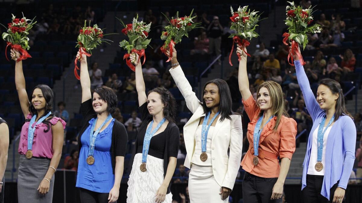 Gymnast Tasha Schwikert, left, and her teammates won the bronze medal at the 2000 Olympics.