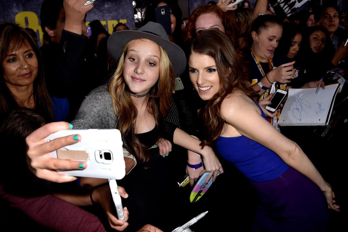 Anna Kendrick poses for a selfie with a fan at the premiere of "Pitch Perfect 2" at the Nokia Theatre on May 8.