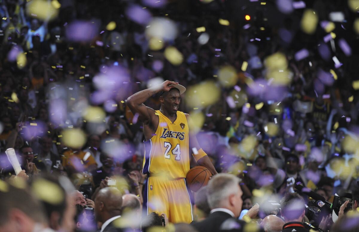 Kobe Bryant stands on the scorers table after the Lakers defeated the Celtics to win the NBA Championship in Game 7.