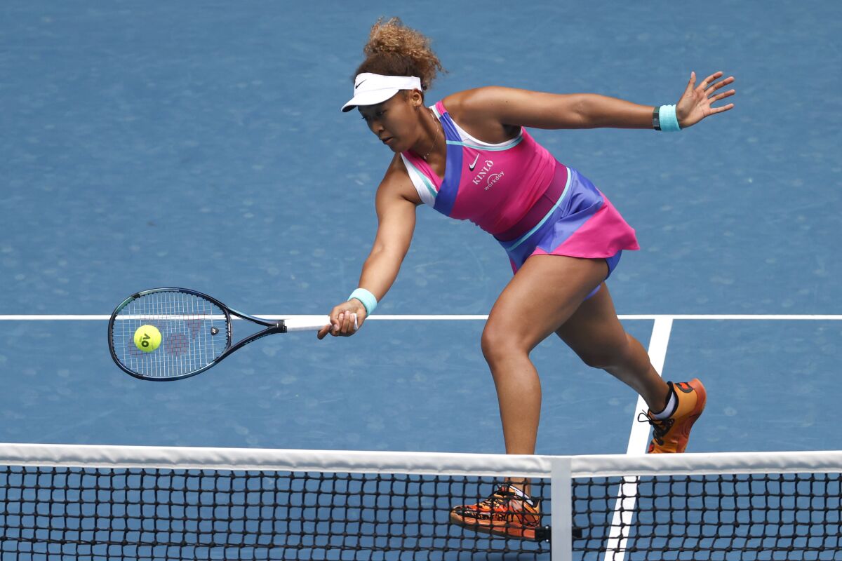 Naomi Osaka of Japan plays a forehand return to Camila Osorio of Colombia during their first round match at the Australian Open tennis championships in Melbourne, Australia, Monday, Jan. 17, 2022. (AP Photo/Hamish Blair)