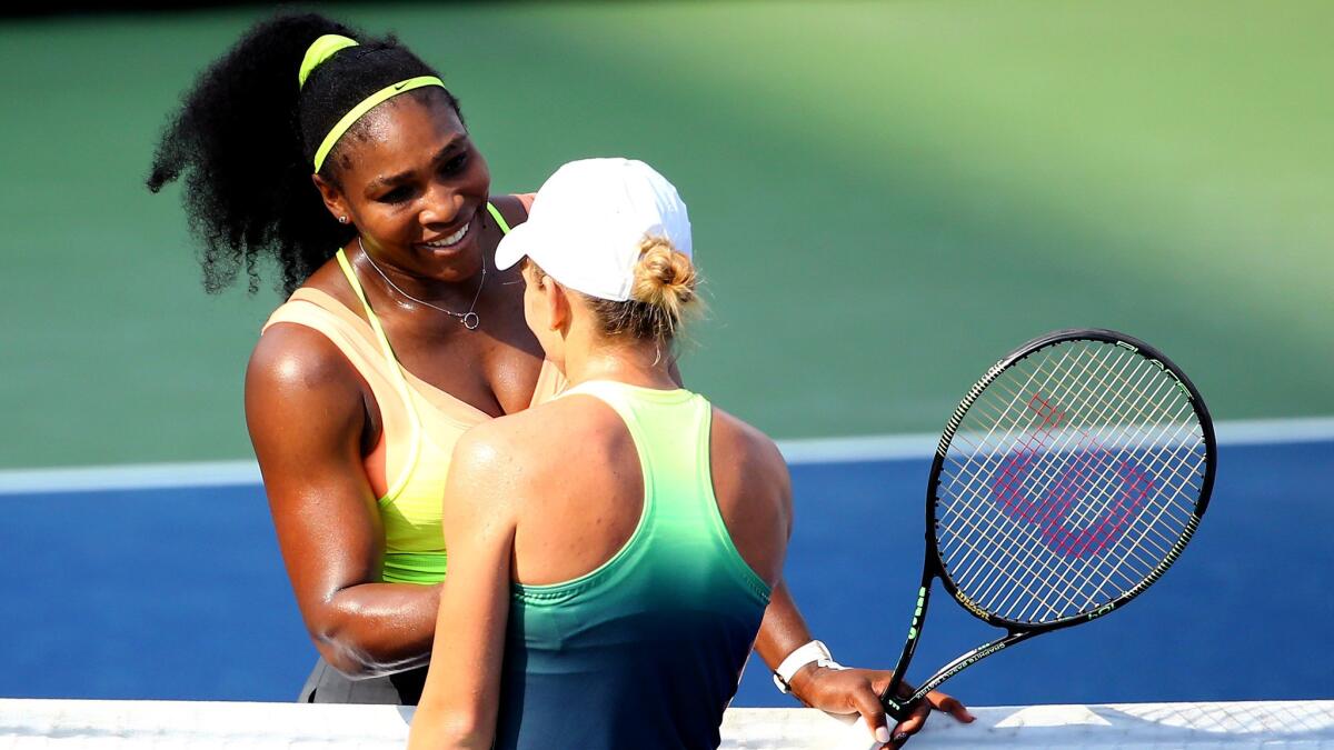 Serena Williams is congratulated by Simona Halep after winning the Western & Southern Open on Sunday.