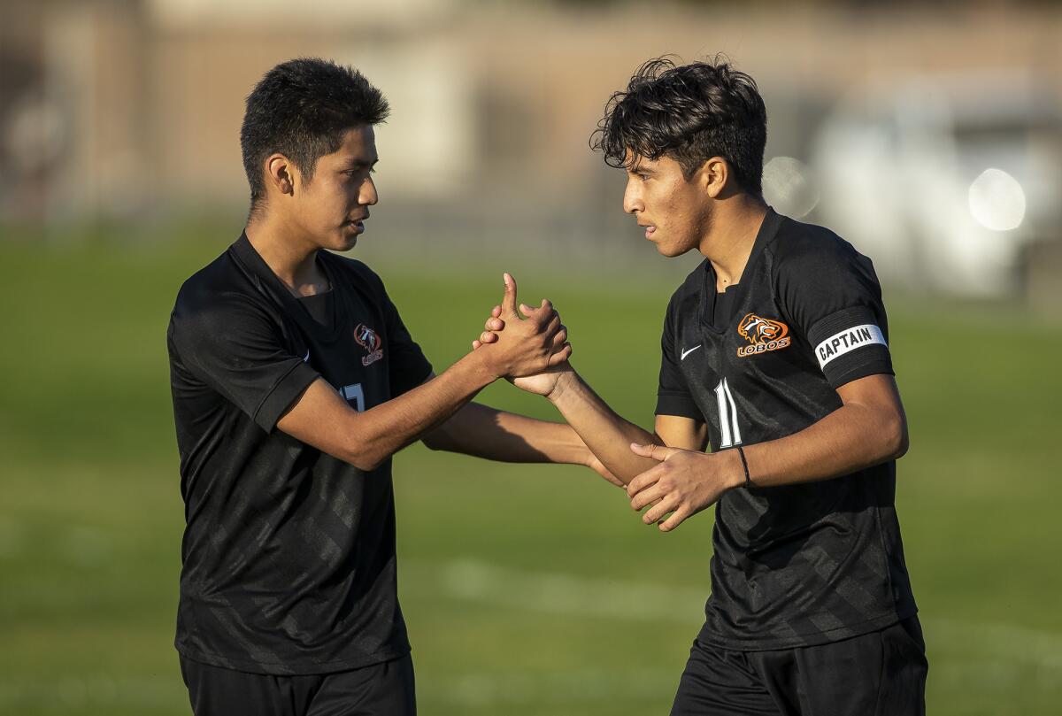 Los Amigos' Anthony Gutierrez, left, congratulates Omar Arciga after he scores a goal against Loara on Jan. 21.