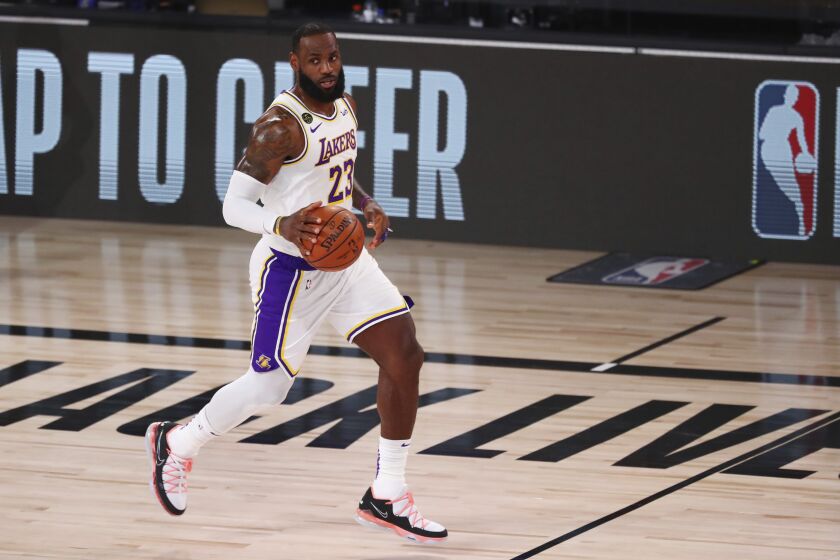 Los Angeles Lakers forward LeBron James (23) brings the ball upcourt against the Utah Jazz during the first half of an NBA basketball game Monday, Aug. 3, 2020, in Lake Buena Vista, Fla. (Kim Klement/Pool Photo via AP)
