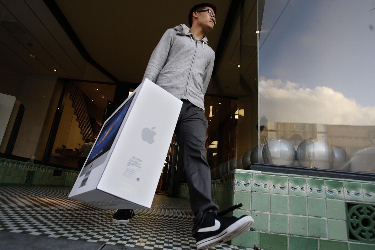 Jason Chen leaves the Apple Store in Pasadena in 2011 after just purchasing a Mac.