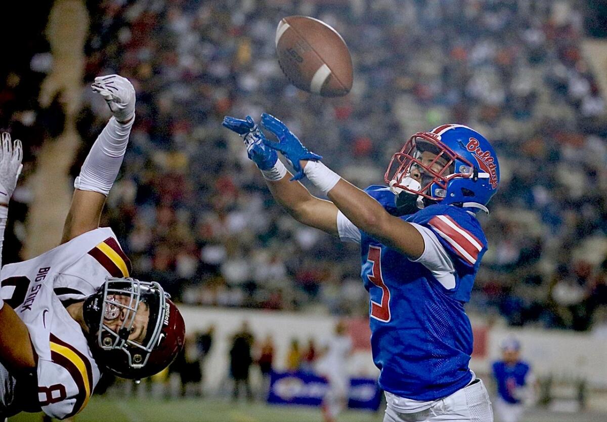 Garfield defensive back Jayden Garcia, right, knocks the ball away from Roosevelt's Esaul Contreras in the first half.