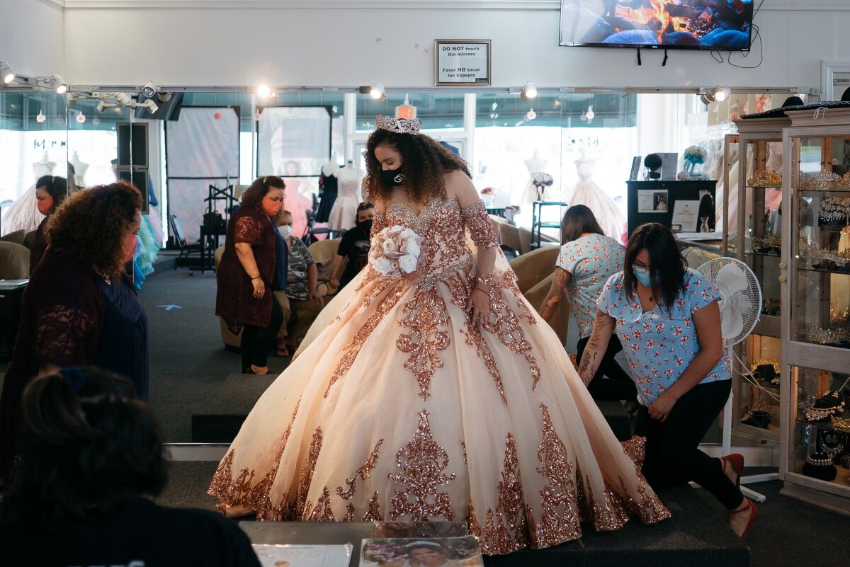 Hennessey De La Cruz is fitted for her quinceanera dress at Lily's Creations in Chula Vista.