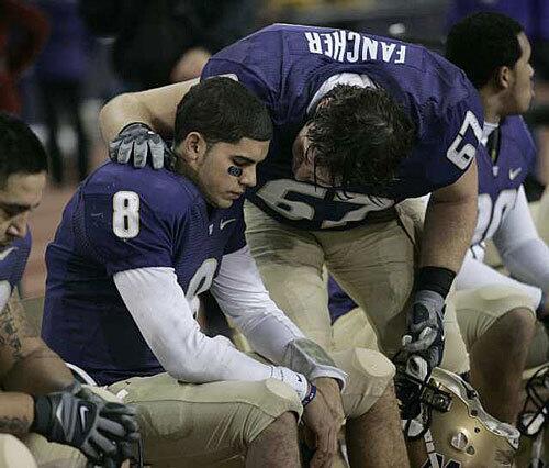 Washington offensive lineman Skyler Fancher consoles quarterback Ronnie Fouch after the Huskies' loss to UCLA.