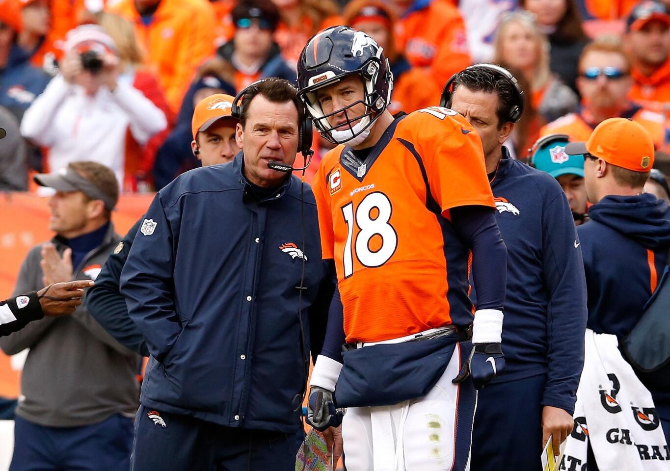 Broncos Coach Gary Kubiak and quarterback Peyton Manning talk during the first half of the AFC Championship game against the Patriots on Jan. 24.