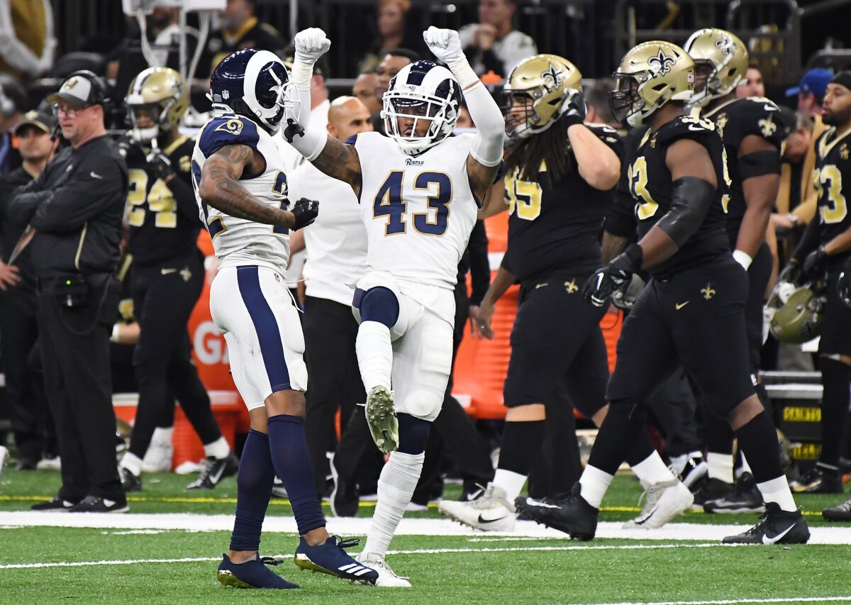 Rams safety John Johnson celebrates his interception against the New Orleans Saints in overtime in the NFC championship game.