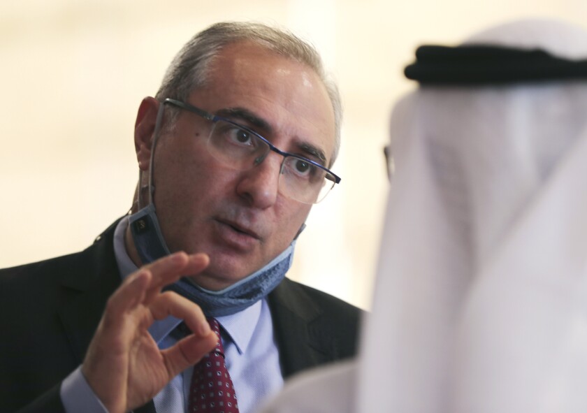 Israel's ambassador to the UAE, Eitan Na'eh talks with an Emirati official during the Global Investment Forum in Dubai, United Arab Emirates, Wednesday, June 2, 2021. At the luxurious Armani hotel inside the world's tallest skyscraper in Dubai, Israelis in kippas and Emiratis in long white robes and kanduras gathered Wednesday to discuss investment opportunities aimed at making the most of deepening ties nine months after the two countries agreed to formalize relations. (AP Photo/Kamran Jebreili)