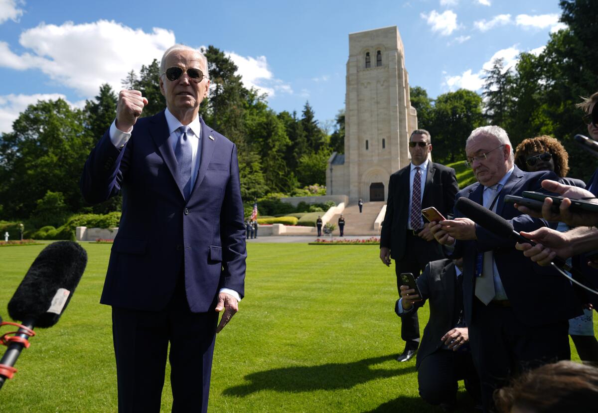 President Biden speaks to the media in a French cemetery 