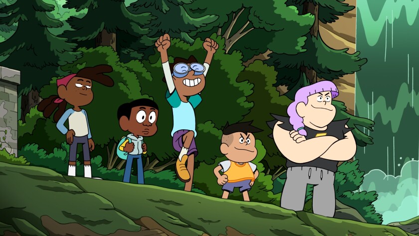 Five kids looking over a cliff at a waterfall