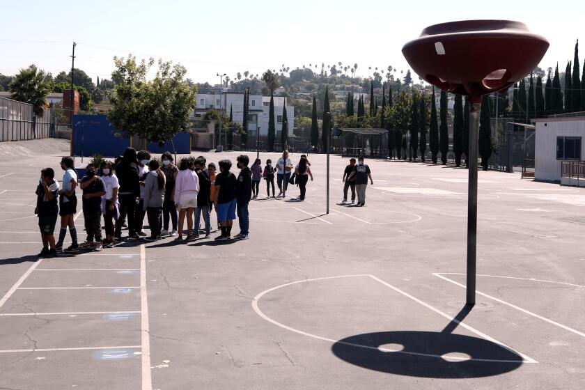 LOS ANGELES, CA - AUGUST 31, 2022 - - With very little shade in sight students prepare to return to class after a midmorning recess at Lockwood Elementary School on August 31, 2022. With temperatures rising in Los Angeles the principal of the school decided that students would not be allowed to play in the yard in the afternoon due to extreme hot weather. Lockwood Elementary School is the number one school in LAUSD's greening index meaning it is the most in need of green space out of all schools. (Genaro Molina / Los Angeles Times) ATTENTION PRE-PRESS: PLEASE DO NOT LIGHTEN FACES AS TO NOT IDENTIFY STUDENTS.