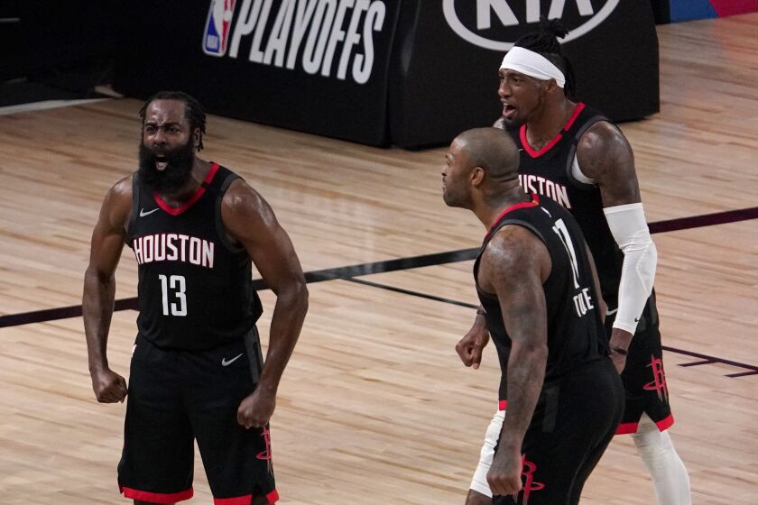 Houston Rockets' James Harden (13), P.J. Tucker, front, and Robert Covington, right rear, celebrate after Harden blocked a Oklahoma City Thunder's Luguentz Dort (5) 3-point shot attempt during the second half of an NBA first-round playoff basketball game in Lake Buena Vista, Fla., Wednesday, Sept. 2, 2020. (AP Photo/Mark J. Terrill)