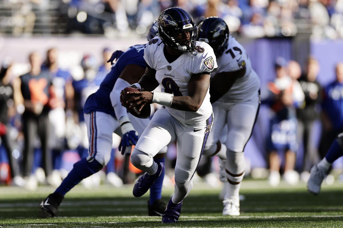Baltimore Ravens quarterback Lamar Jackson runs with the ball against the New York Giants.