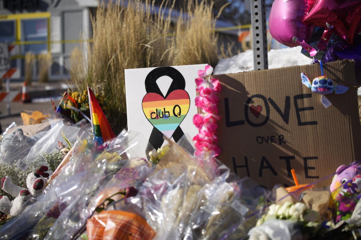 Bouquets sit on a corner near the site of a mass shooting at Club Q in Colorado Springs, Colo.