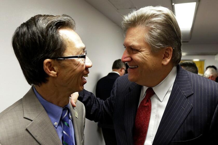 Assemblyman Ed Chau, D-Arcadia, left, and Sen. Bob Hertzberg, D-Van Nuys, celebrate after their internet privacy bill was approved by the Senate Judiciary Committee, Tuesday, June 26, 2018, in Sacramento, Calif. The bill would let consumers ask companies to delete their information or refrain from selling it, among other data privacy provisions. The bill, which is aimed to keep a related initiative off the November ballot. (AP Photo/Rich Pedroncelli)