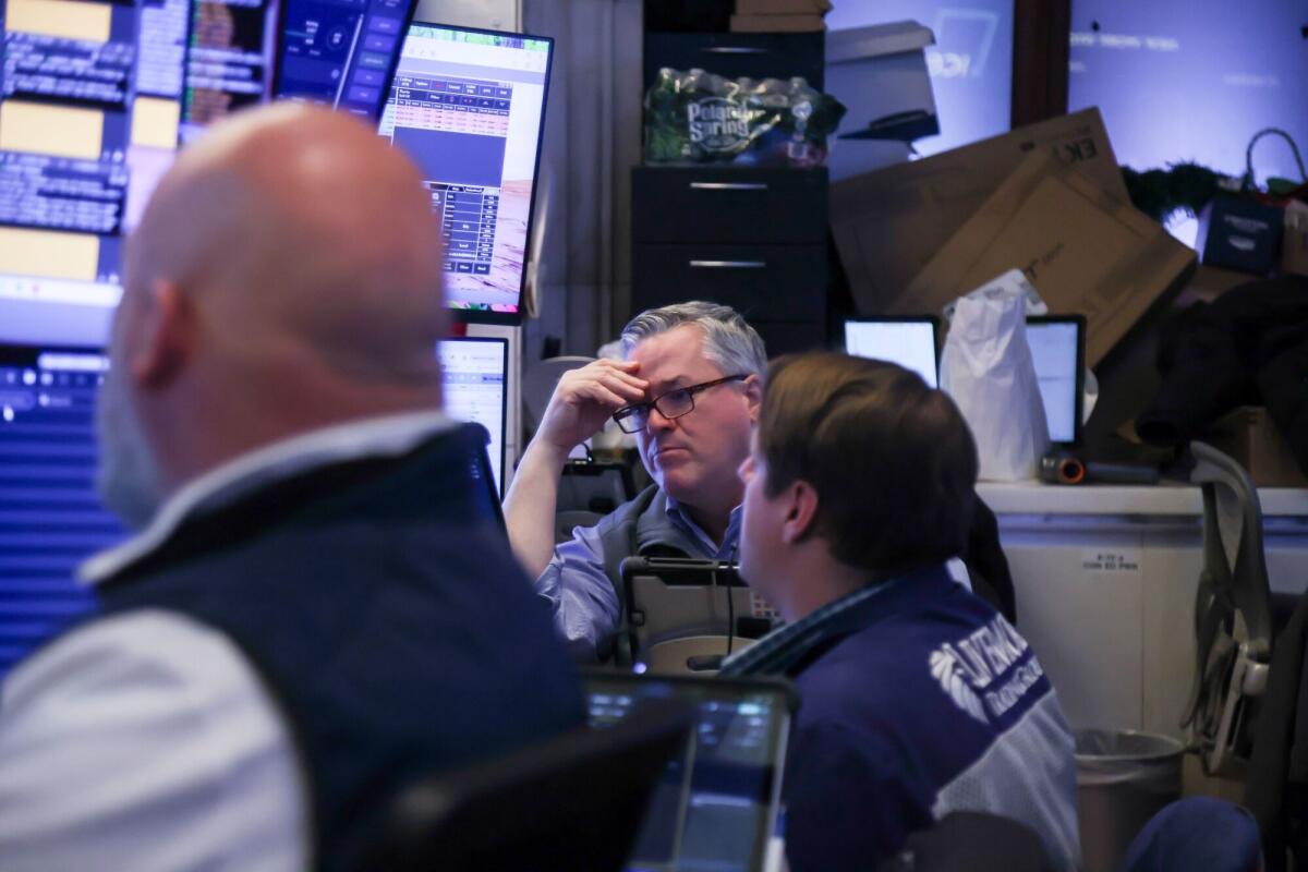 Traders work on the floor of the New York Stock Exchange.